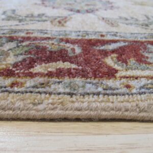 Low-pile rug edge shows red and beige traditional patterns resting on light wood floorboards.