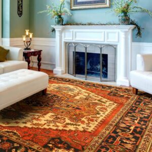 A traditional rust, black, and cream patterned rug anchors a living room with mint walls and white tufted furniture.