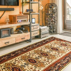 Cream, red, and blue geometric rug runner on light flooring next to a wood and metal shelf.