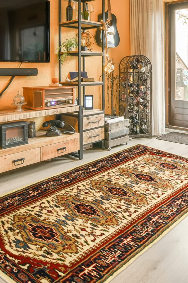 Cream, red, and blue geometric rug runner on light flooring next to a wood and metal shelf.