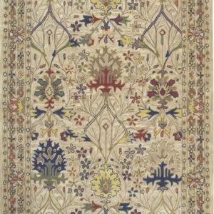 Beige field rug with an elaborate multicolored traditional floral and foliate design and white fringe.