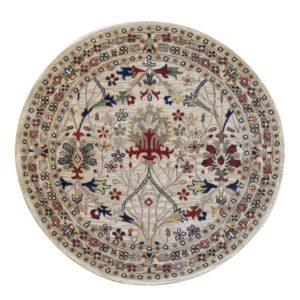 Traditional round rug with a dense multicolored floral design on a light beige background.