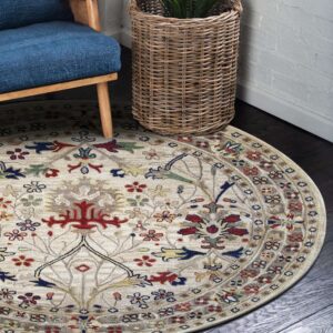 Beige round rug with red and blue traditional floral pattern next to a wicker planter and blue chair.