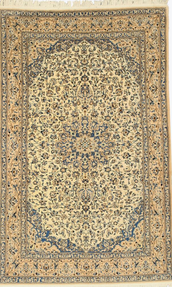 Ornate low-pile rug with blue and tan floral designs on an ivory background and visible fringe.