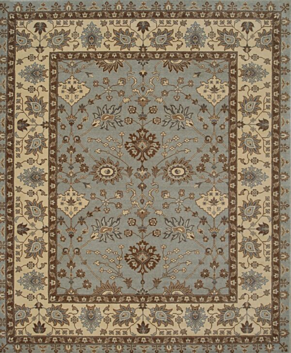 Muted blue floral rug featuring detailed traditional patterns, outlined by broad cream and brown borders.