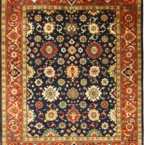 A navy blue rug with a traditional repeating floral pattern and a wide rust red border.