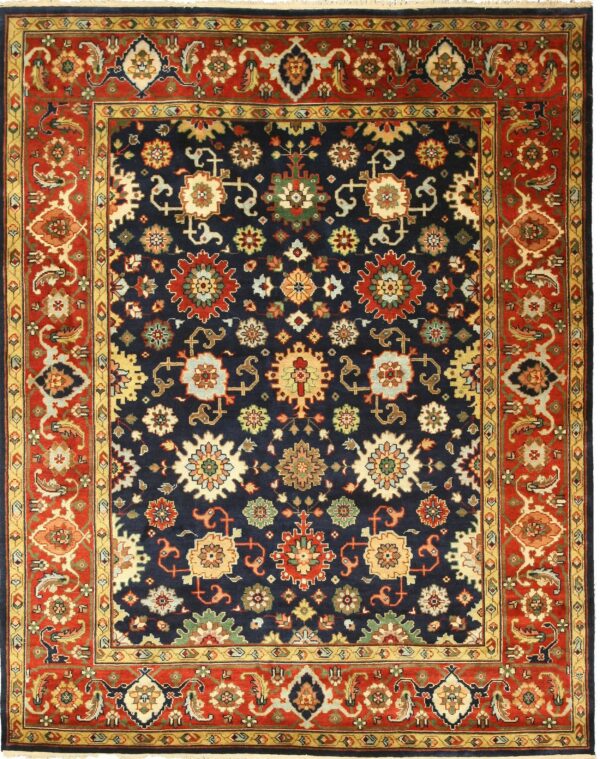 A navy blue rug with a traditional repeating floral pattern and a wide rust red border.