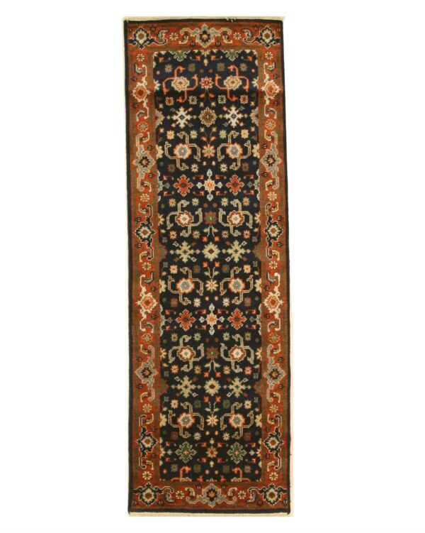 Black runner rug with an elaborate geometric floral pattern and a wide rust colored border.