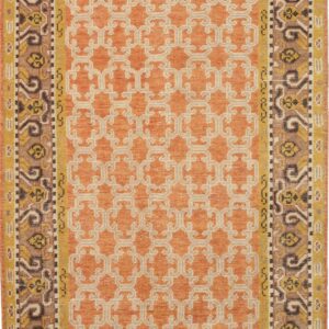 Orange rug with a beige geometric field pattern and multi-colored traditional borders in brown and yellow.