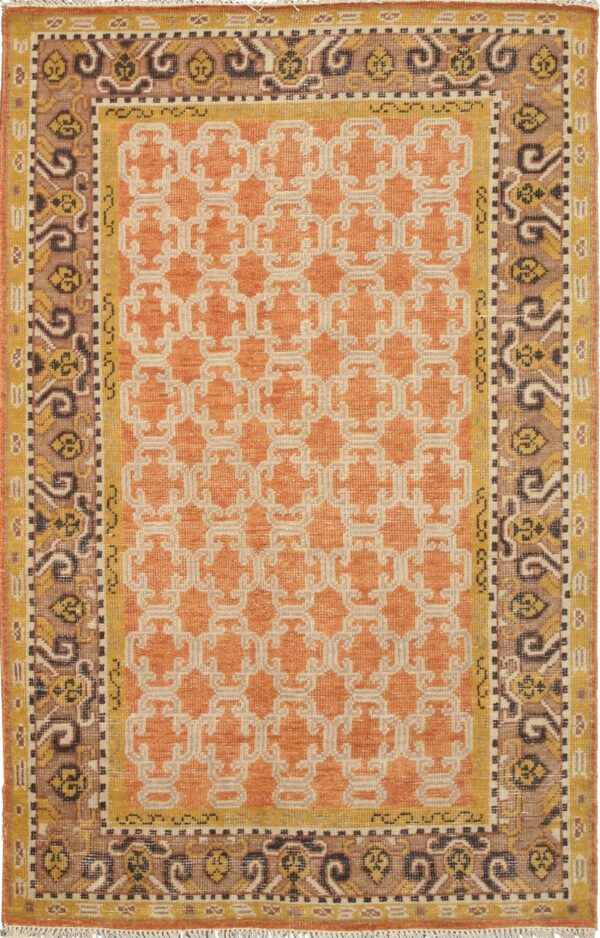 Orange rug with a beige geometric field pattern and multi-colored traditional borders in brown and yellow.