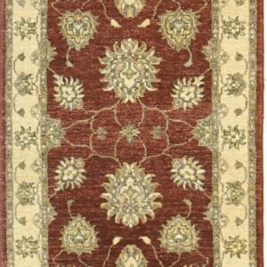 Vertical runner rug with a rust-red field and repeating cream and olive traditional floral designs.