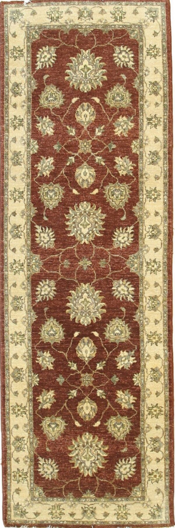 Vertical runner rug with a rust-red field and repeating cream and olive traditional floral designs.