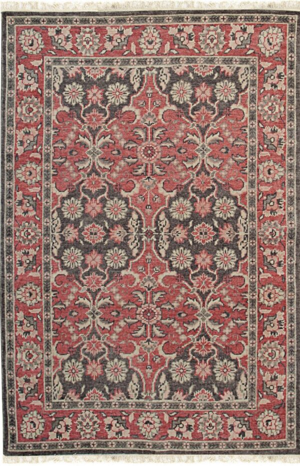 Low-pile rug with red, charcoal, and beige traditional floral patterns and visible fringe.