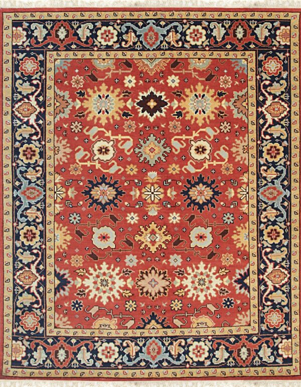 Rust red traditional rug with dense stylized florals and a complex navy and gold border.