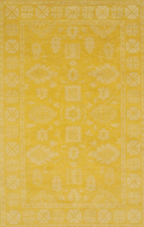 Bright yellow rug with a faded traditional pattern and distinct geometric borders.