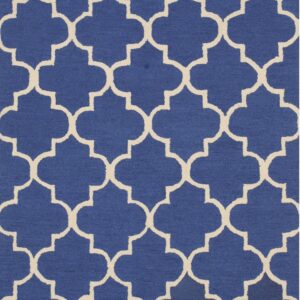 Royal blue low-pile rug with a high-contrast cream geometric quatrefoil trellis design.