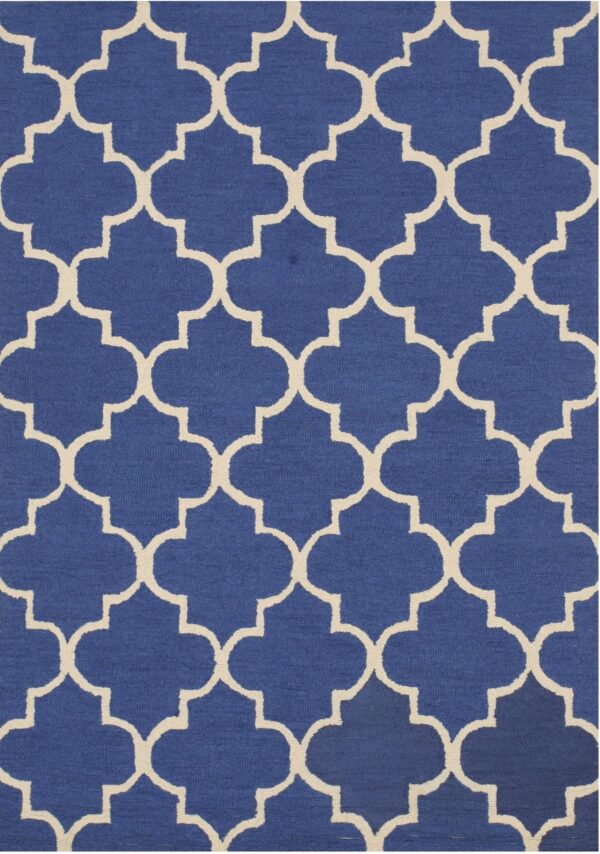 Royal blue low-pile rug with a high-contrast cream geometric quatrefoil trellis design.