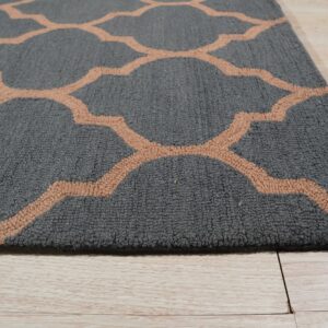 A textured gray rug with a light brown quatrefoil pattern rests on pale wood planks.