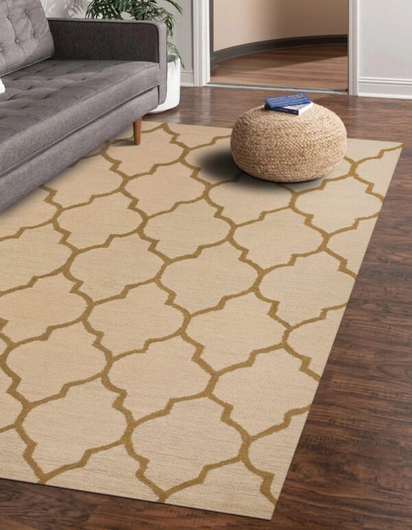 Low-pile beige rug with a golden brown lattice pattern anchors a gray sofa and woven pouf.