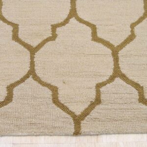 Beige looped rug featuring a thick mustard gold quatrefoil pattern on light wood plank flooring.