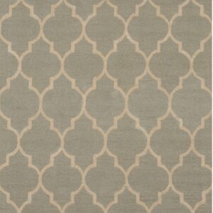 Geometric rug with low pile in muted sage green and repeating beige quatrefoil motif.