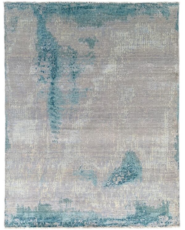 Modern abstract rug featuring distressed patches of teal and aqua on a shimmering gray background.
