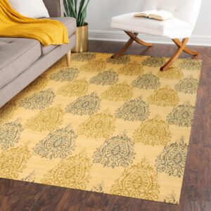 Yellow rug featuring olive and gray paisley motifs anchors a gray sofa on dark wood flooring.