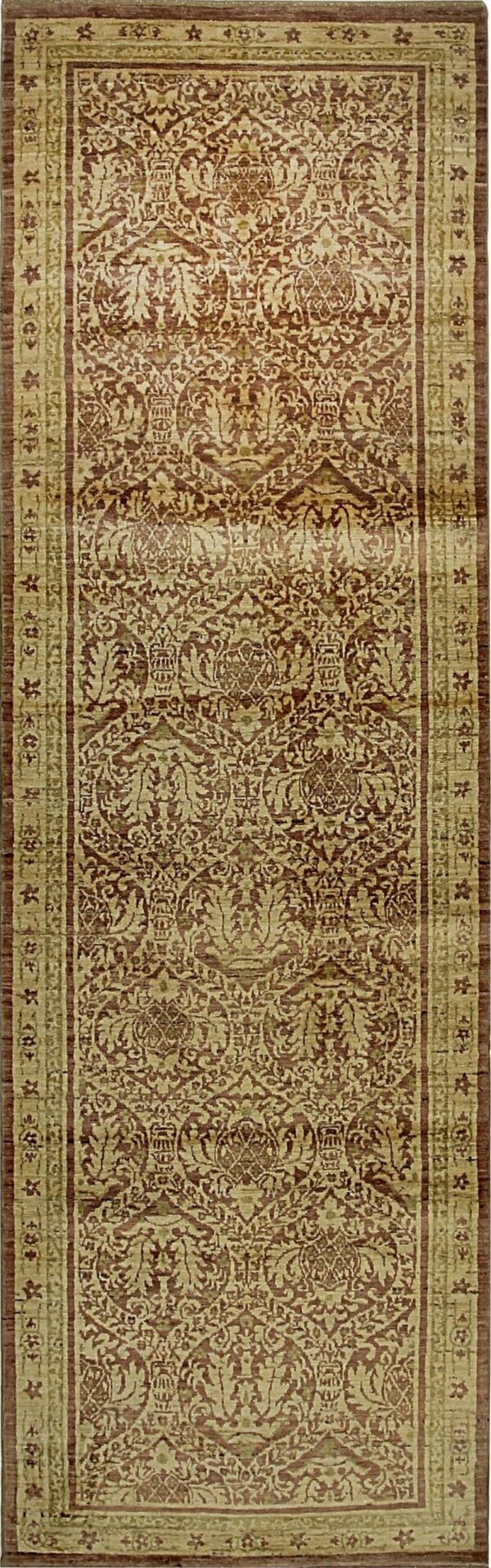 Ornate runner rug with light tan ornamental motifs contrasting against a dark reddish-brown field.