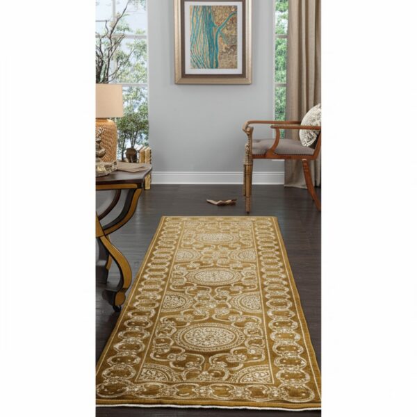 Gold and cream traditional runner rug extends down a dark wood hallway near a console table and chair.