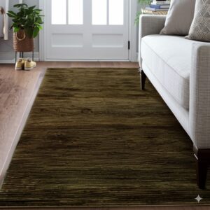 Dark green striated rug on wood flooring next to a gray sofa and a white paneled door.