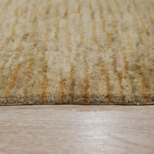 High-pile beige rug with irregular yellow striping rests on light wood plank flooring.