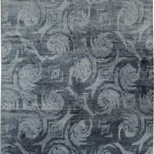 Slate gray rug with a light gray abstract pattern featuring large swirling and blurred geometric designs.