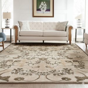 Low pile beige rug with a symmetrical brown floral pattern sits beneath a white tufted sofa.