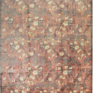 Coral rug with an allover distressed pattern of dark gray damask and cream-colored trailing flowers.
