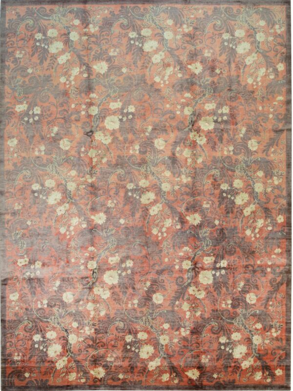 Coral rug with an allover distressed pattern of dark gray damask and cream-colored trailing flowers.