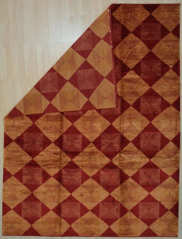 Geometric rug with alternating burgundy and textured gold diamonds displayed on light plank flooring.