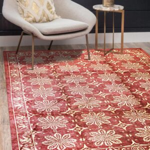 Burgundy rug with cream floral and geometric patterns visible under a gray chair on wood flooring.