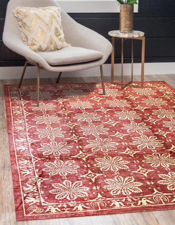 Burgundy rug with cream floral and geometric patterns visible under a gray chair on wood flooring.