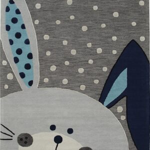 A dark gray rug with raised white dots features a light gray bunny face with blue patterned ears.