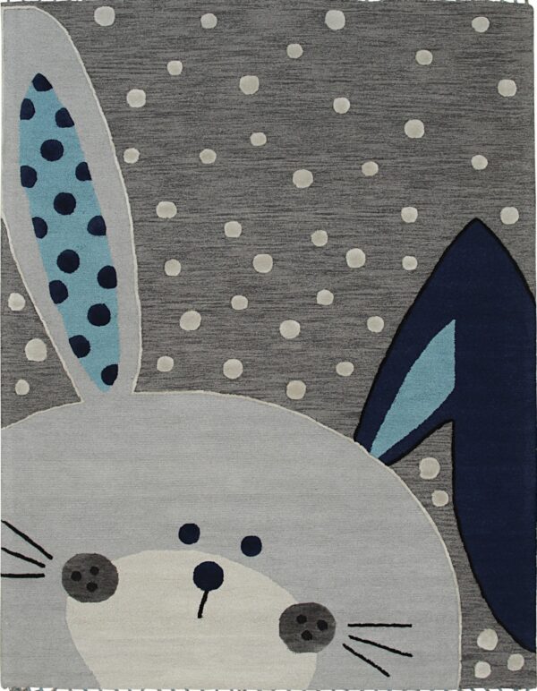 A dark gray rug with raised white dots features a light gray bunny face with blue patterned ears.