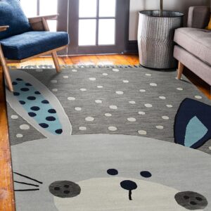 Gray polka dot rug featuring a large rabbit face with blue patterned ears on a hardwood floor.