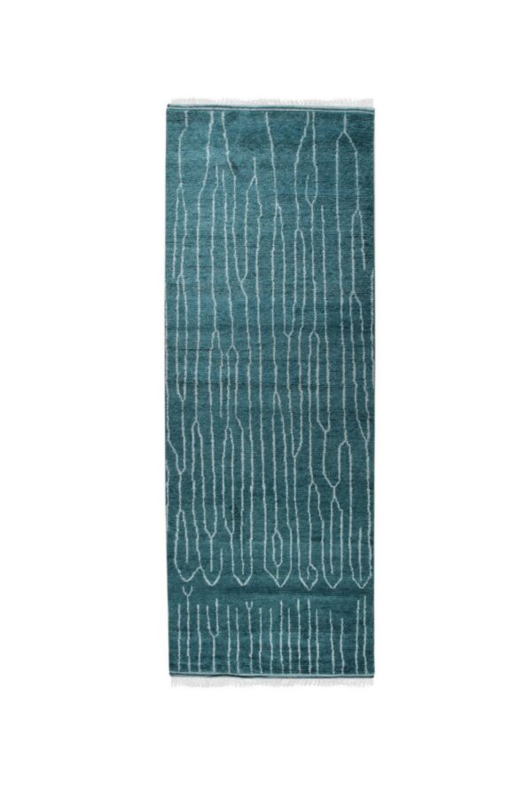Teal runner rug featuring white abstract vertical lines and short fringe displayed on a white background.