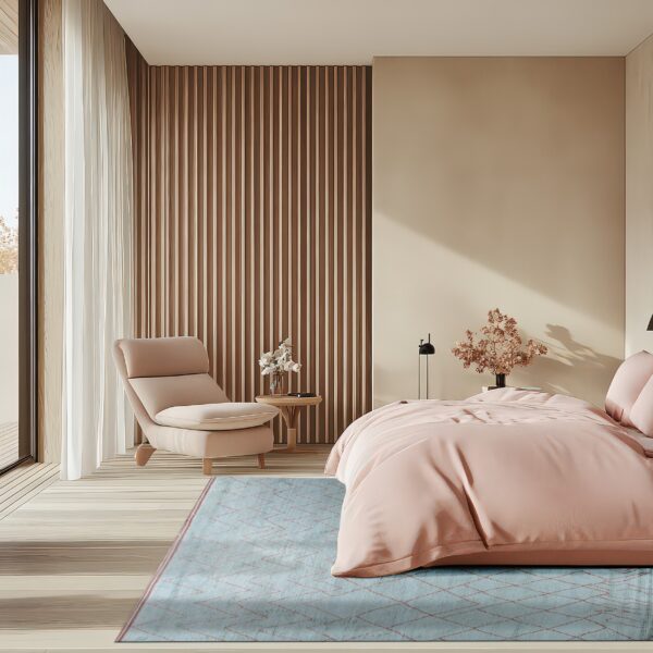 A blue low-pile rug with a copper geometric pattern lies under a pink bed in a sunny modern bedroom.