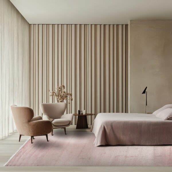 Light pink rug covers a light wood floor in a bedroom with beige ribbed walls and velvet chairs.
