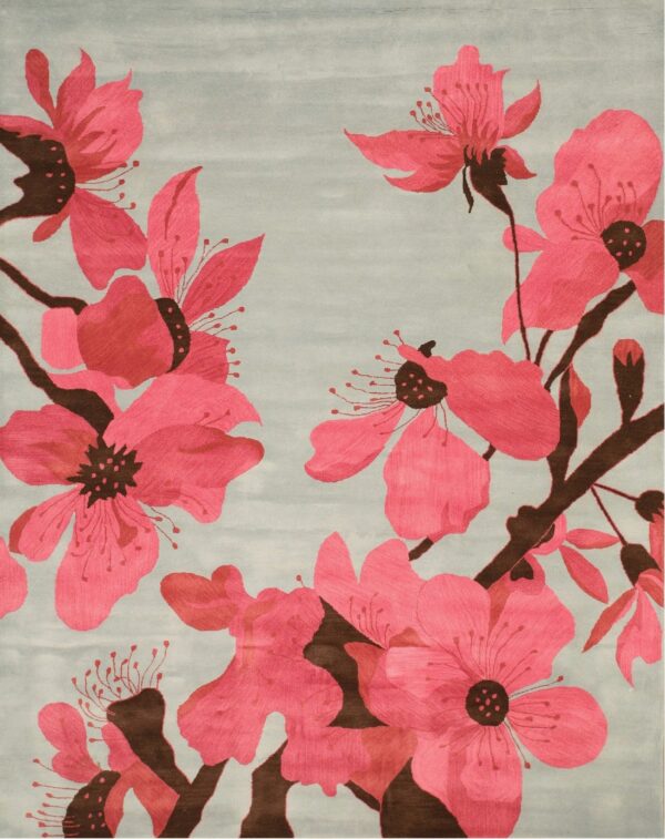 Large fuchsia flowers and dark brown branches cover a rug with a muted light blue-gray background.