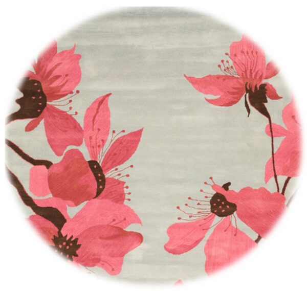 Light gray rug with large pink and brown stylized flowers around the border.
