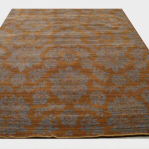 Rectangular rug with a striated rust background and large repeating gray floral pattern.