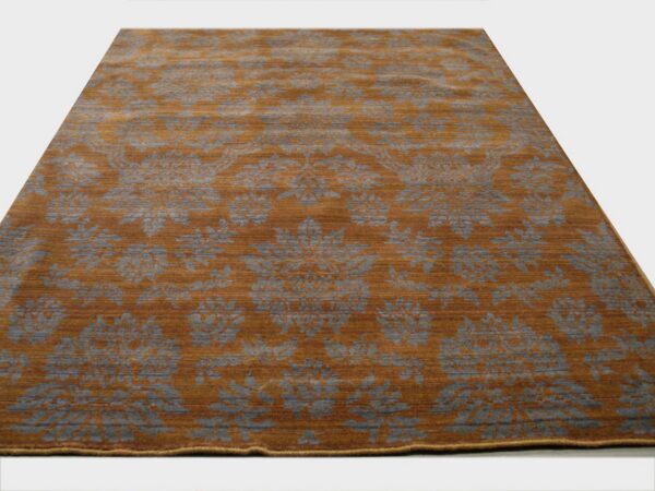 Rectangular rug with a striated rust background and large repeating gray floral pattern.