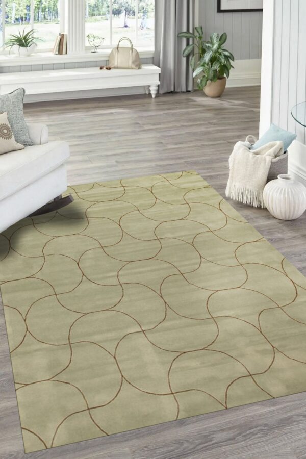 Muted green low-pile rug with thin brown abstract curve pattern resting on gray wood plank flooring.
