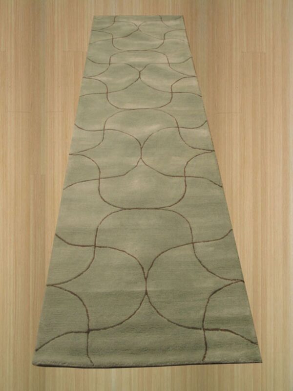 A plush sage runner rug with repeating brown ogee patterns sits on light wood flooring.